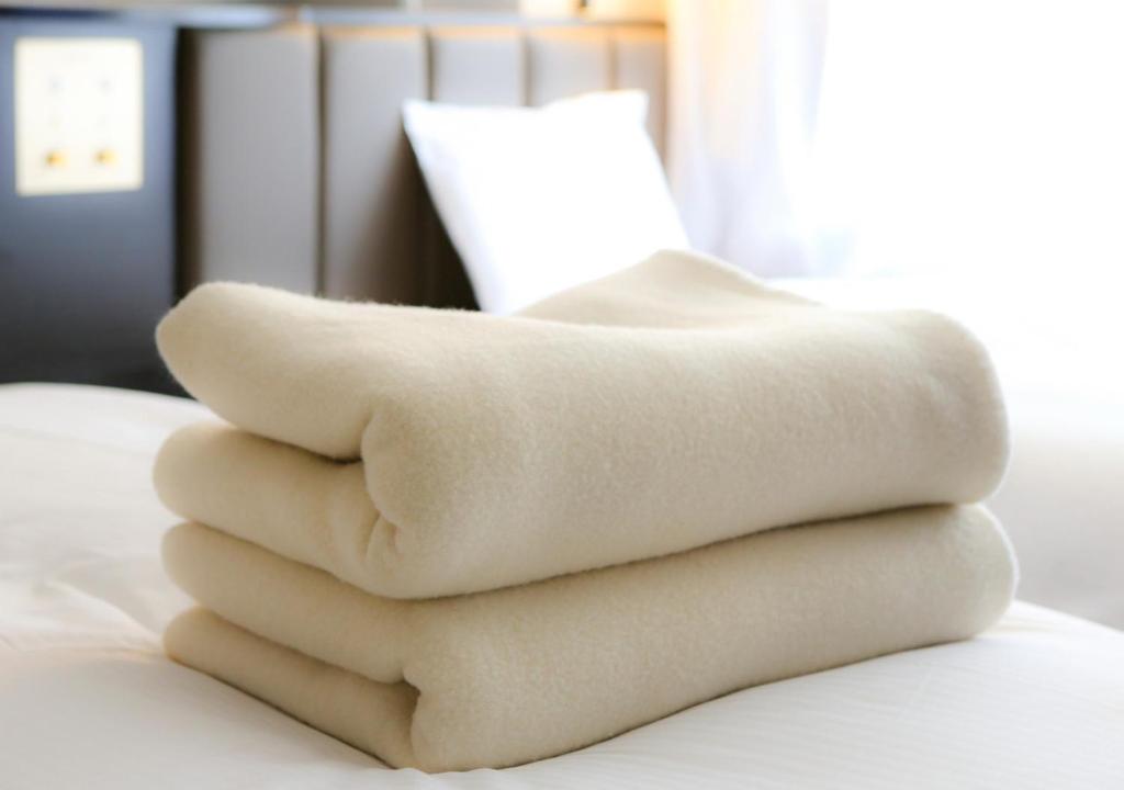 Postel nebo postele na pokoji v ubytování APA Hotel Niigata Higashinakadori