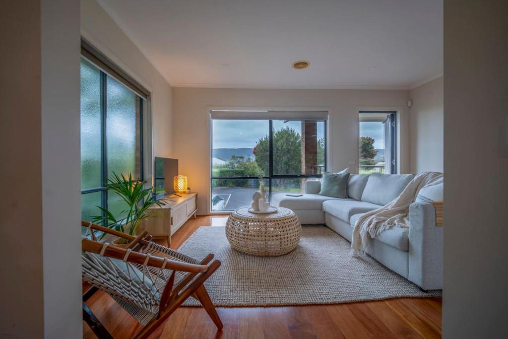 a living room with a couch and a table at Spacious beachside family home in Rosebud