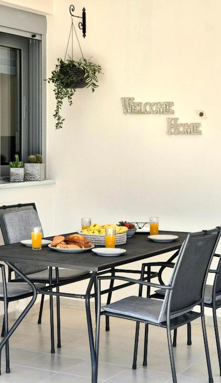 a black table with chairs and a plate of food on it at Idene Penthouse in Chania