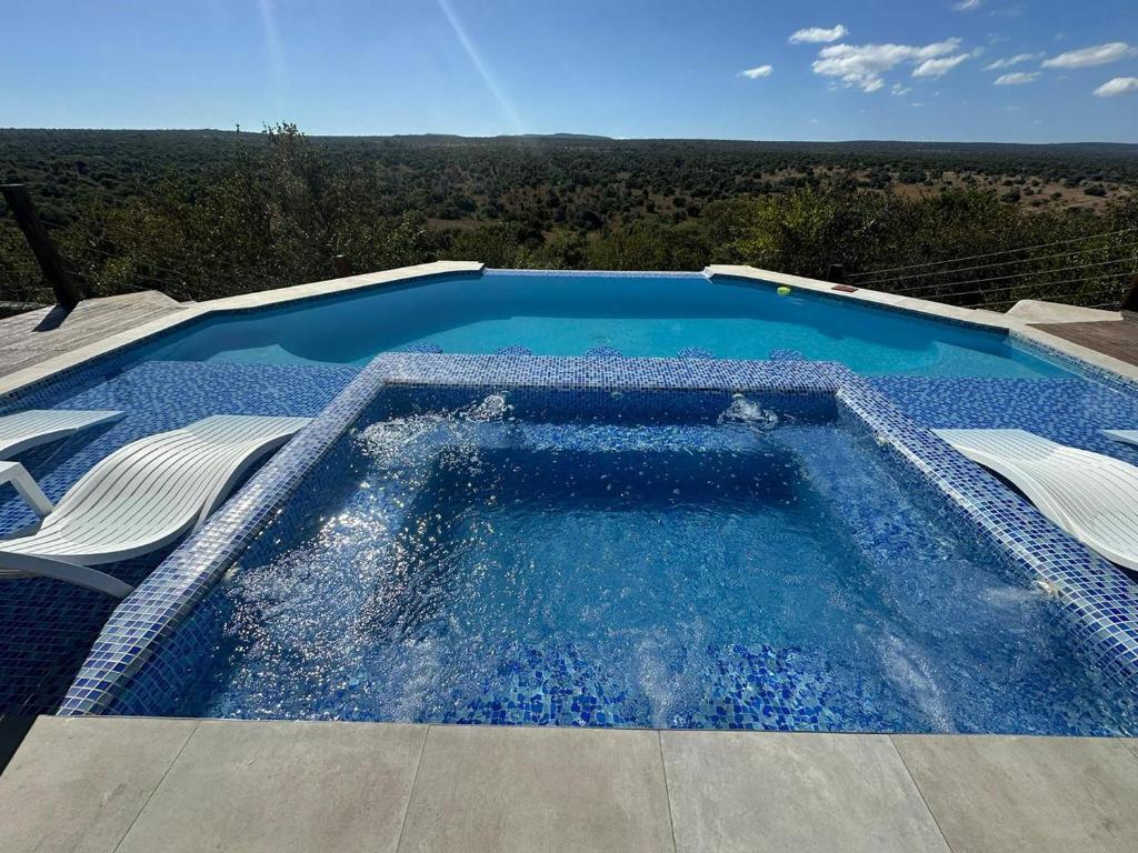 a swimming pool on top of a house at Tebuah Private Lodge, Mabalingwe in Mabula