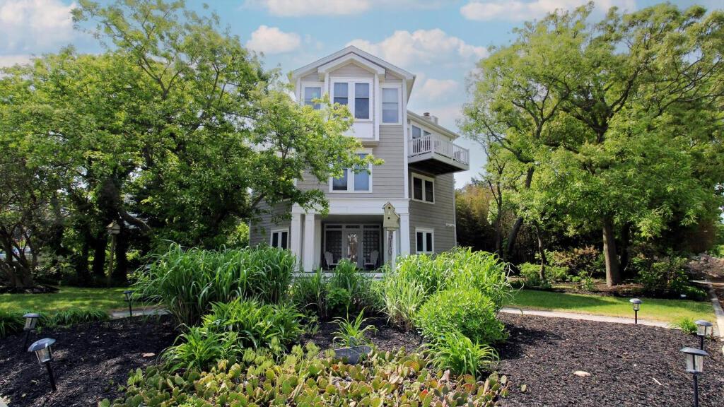 a house with a garden in front of it at 516 Mistletoes In The Sand, Cape May Beach in Villas