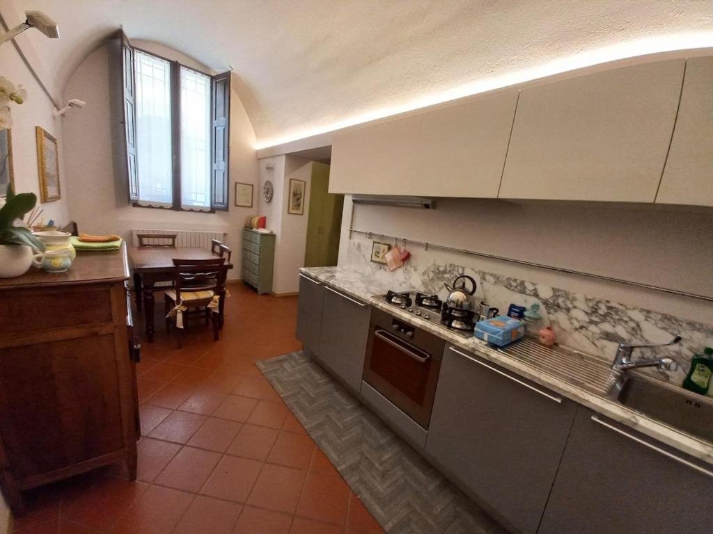 a kitchen with a sink and a counter top at Dal Teatro - Imola Centro in Imola