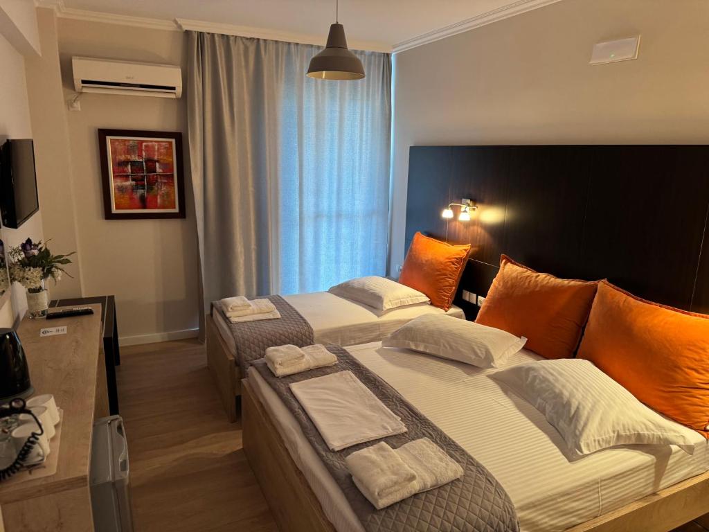 Postel nebo postele na pokoji v ubytování George Hotel Rooms&Suites