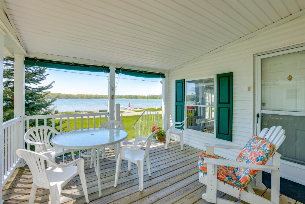 a porch with a table and chairs and a view of the water at Tallman Lake Access Family-Friendly Home with Dock! in Fountain