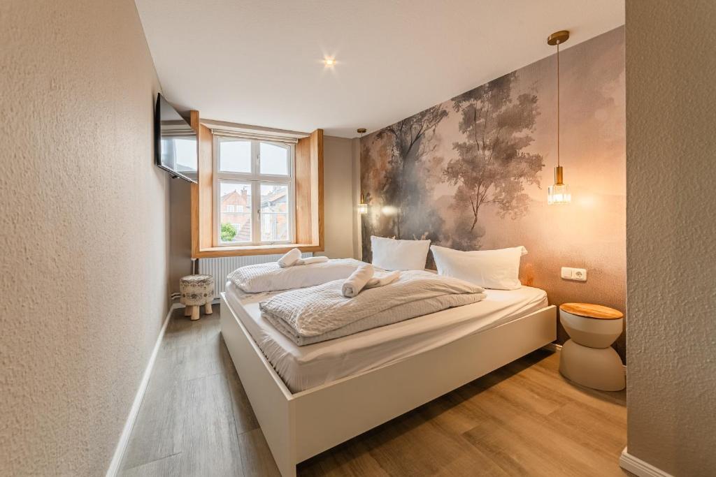 a bedroom with a large bed and a window at Hotel Seepferdchen Zimmer 5 Eckernförde in Eckernförde