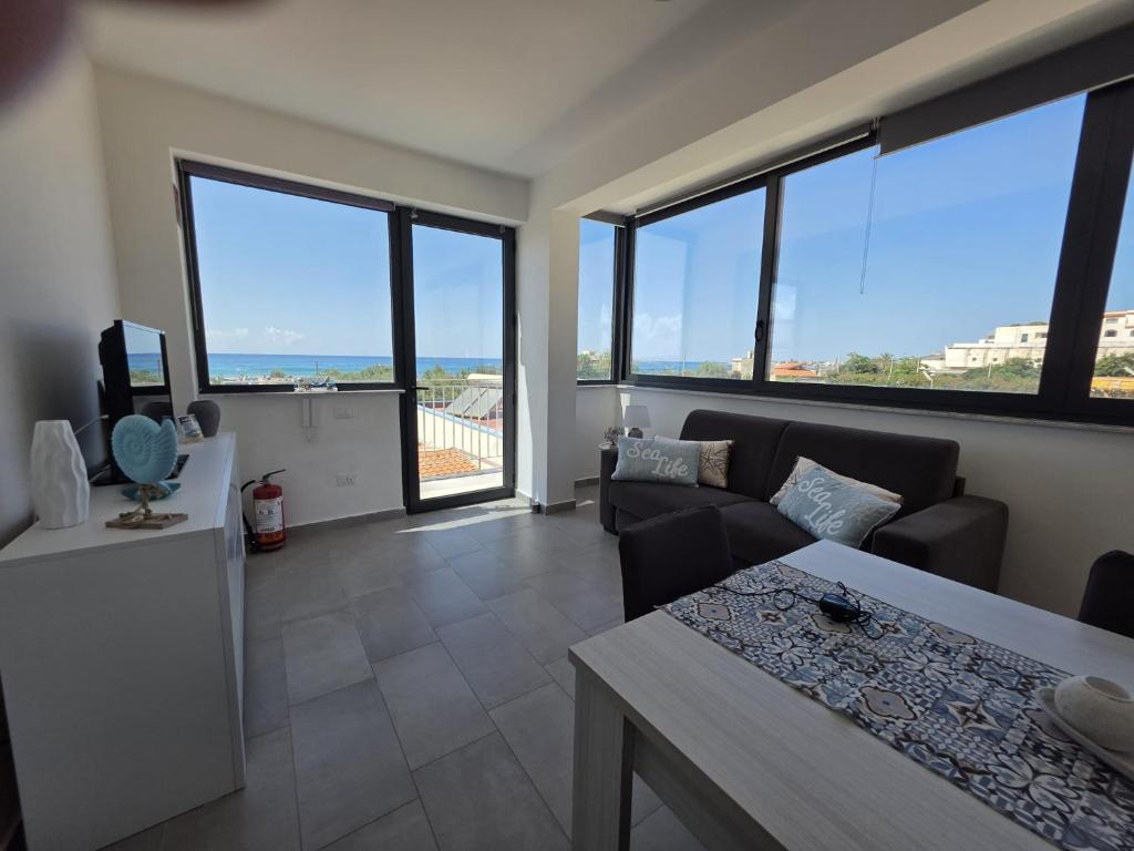 a living room with a couch and a table at A Casa di Angela in Capaci