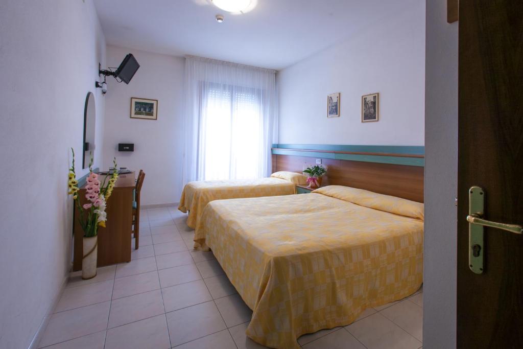 Postel nebo postele na pokoji v ubytování Hotel Grand Prix