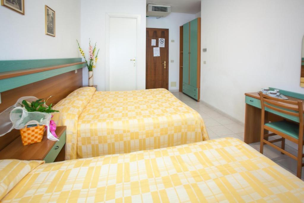 Postel nebo postele na pokoji v ubytování Hotel Grand Prix