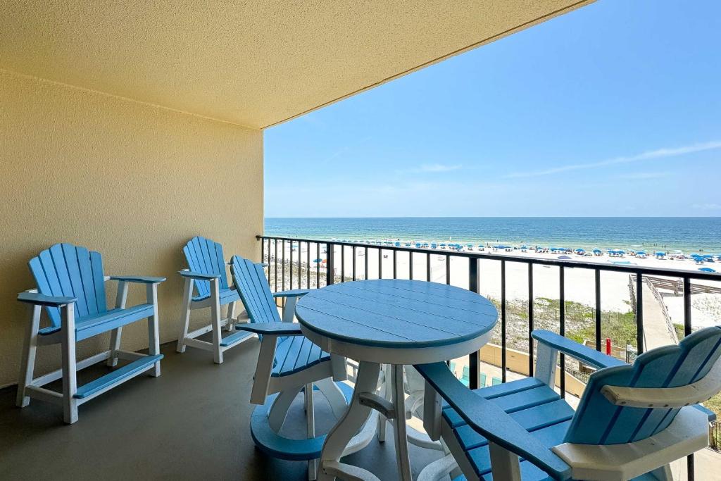 a balcony with a table and chairs and the beach at Phoenix 2 Unit 2034 in Orange Beach