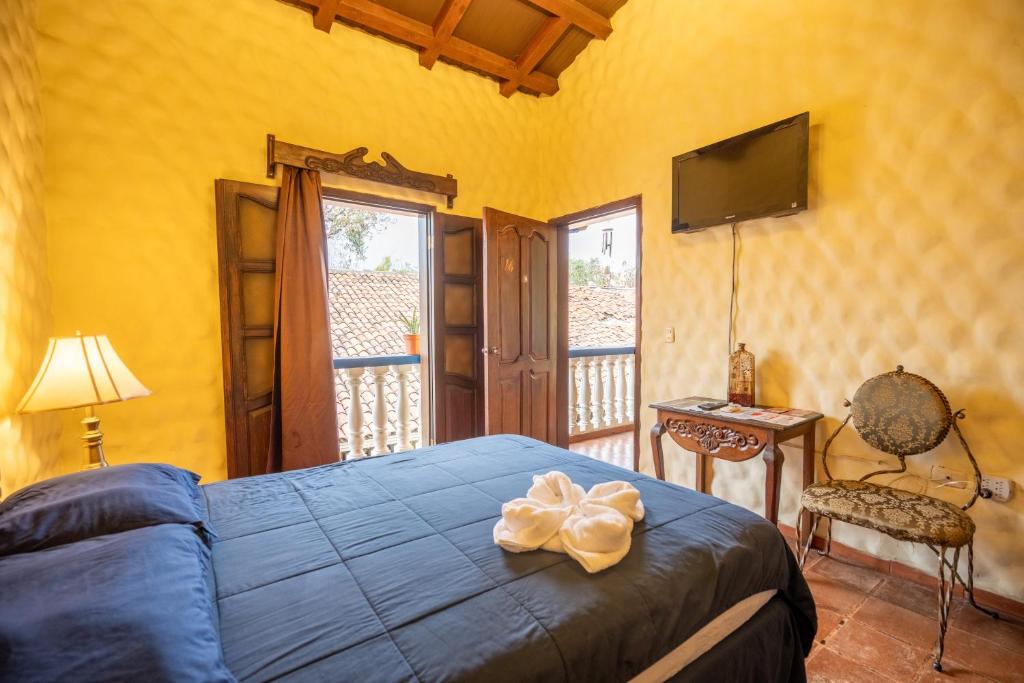 Ένα ή περισσότερα κρεβάτια σε δωμάτιο στο Hotel Caxa Real