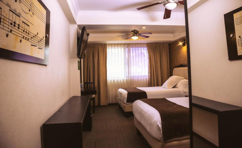 Postel nebo postele na pokoji v ubytování Hotel Clara Luna