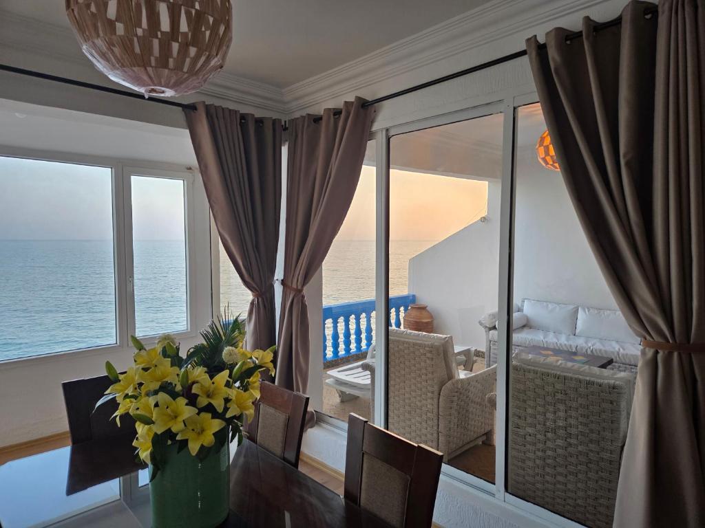 a dining room with a view of the ocean at Terrasse sur l'azur in Taghazout