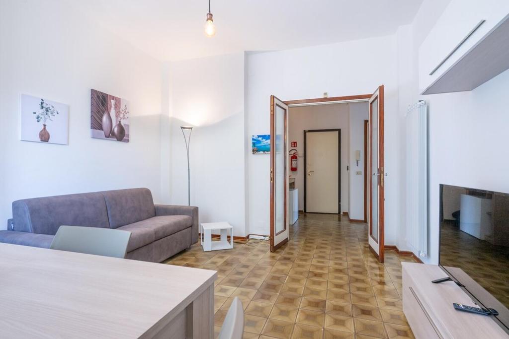 a living room with a couch and a table at La Casa del Sole-Viareggio in Viareggio
