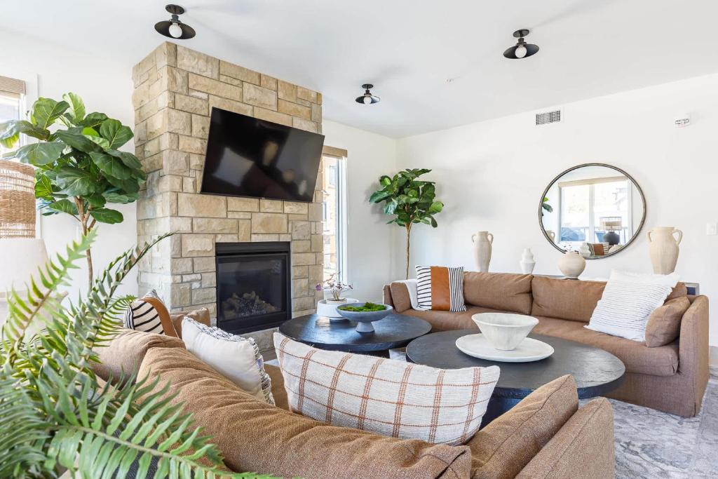 a living room with a couch and a fireplace at Creekside Elegance at Timberstone in Canmore