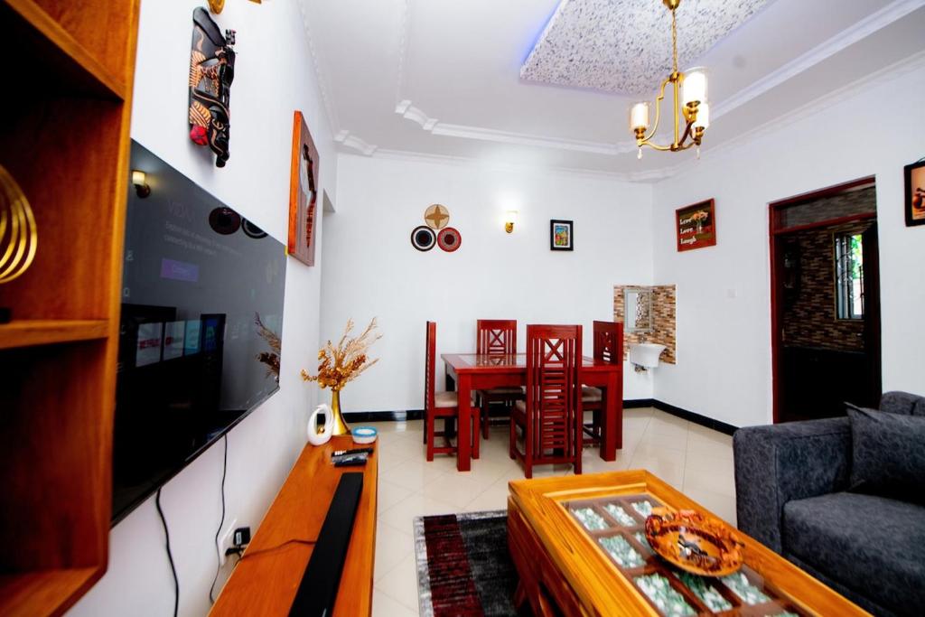 a living room with a couch and a table at Private Nest Apartment 2 in Arusha