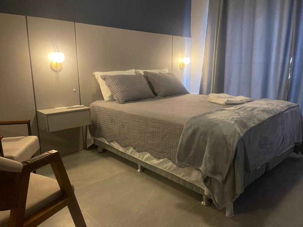 a bedroom with a large bed with two pillows at Madrid Apartment in São Paulo