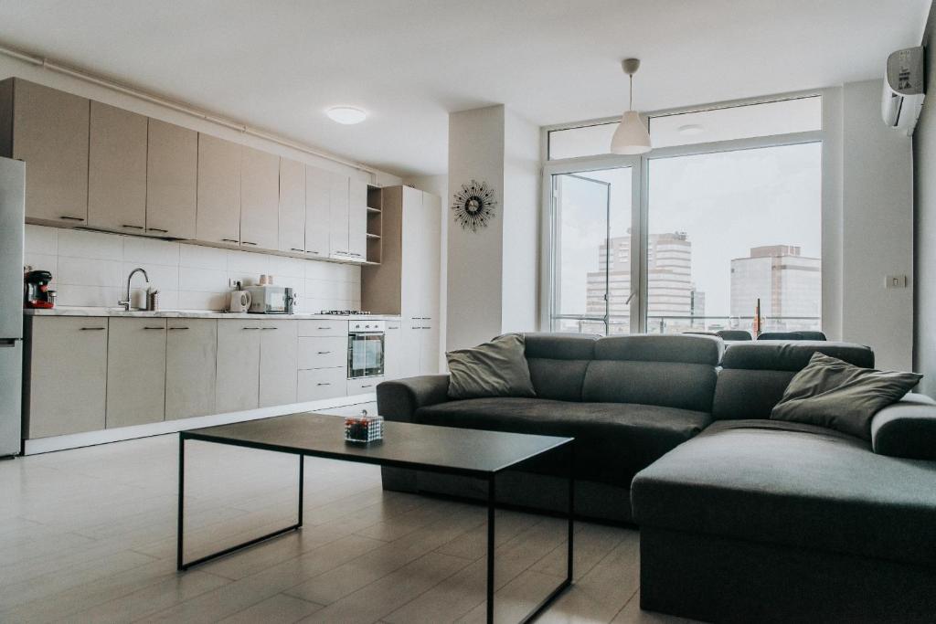 a living room with a couch and a table at Apartament Nord One in Timişoara
