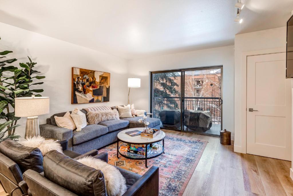 a living room with a couch and a table at Park Station Luxury Retreat in Park City