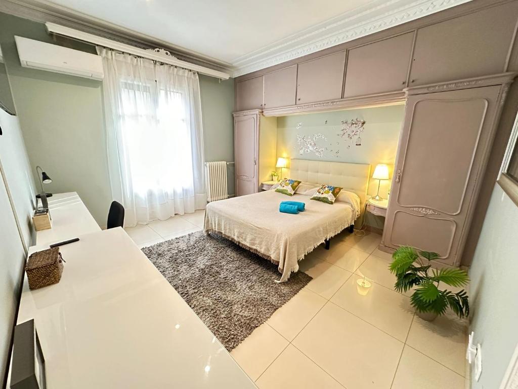 a bedroom with a bed and a large window at Rooms Granvia in Barcelona