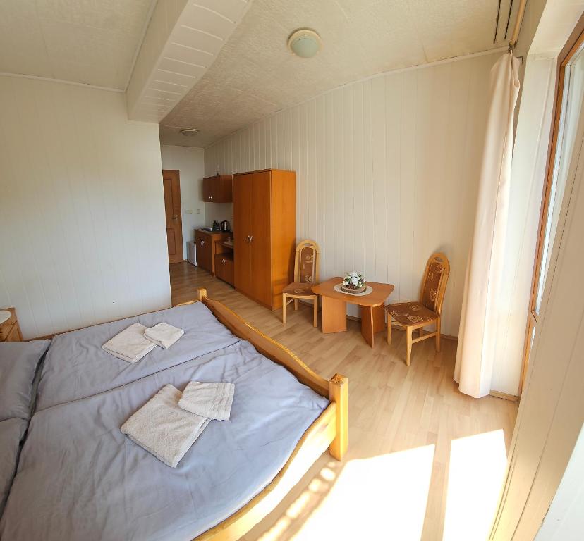 a bedroom with a bed and a table in it at Chalúpka v Rajeckých in Žilina