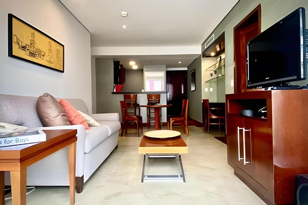 a living room with a couch and a table at Itaim Alto Padrão 2suítes MobInn 803 in Sao Paulo