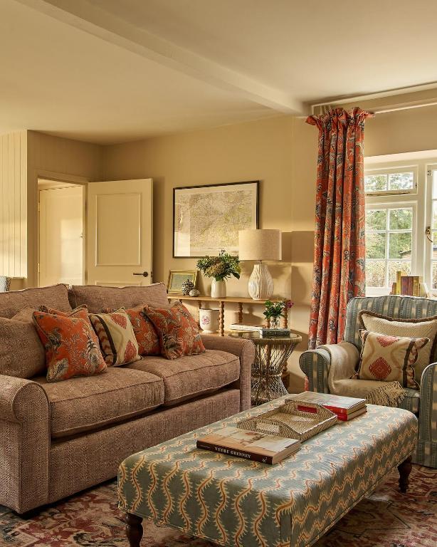 a living room with a couch and a table at Haybarn Cottage in Alton