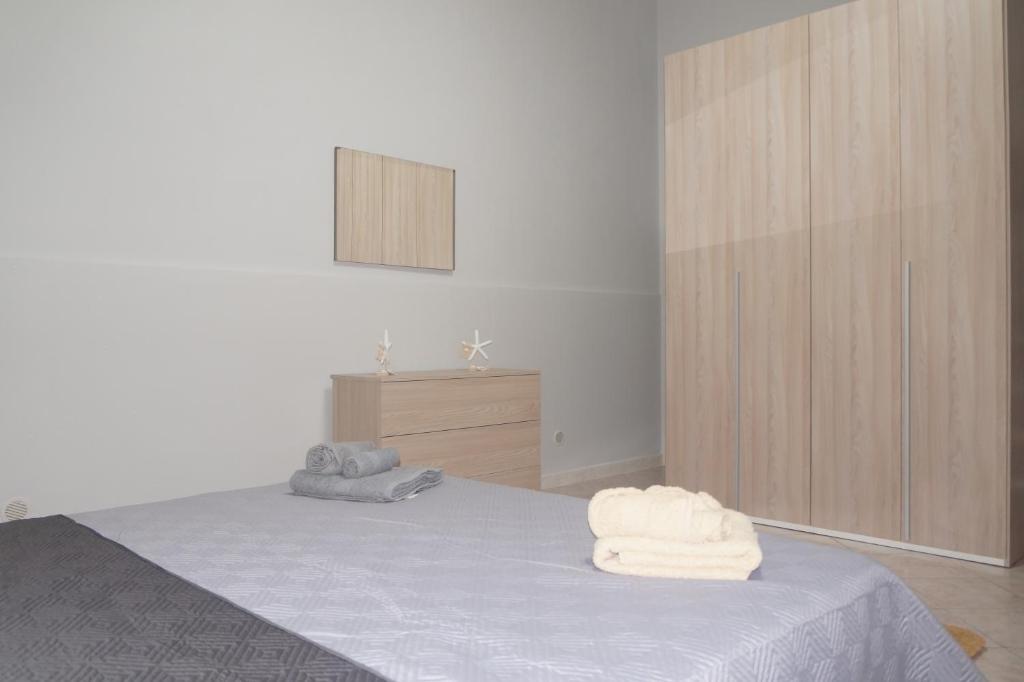 una camera da letto con un letto con asciugamani sopra di Holiday Home Palermo - Centro Storico a Palermo