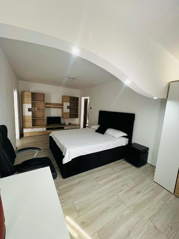 a bedroom with a large bed in a room at Apartament Tudorache Premium 1 in Turceni