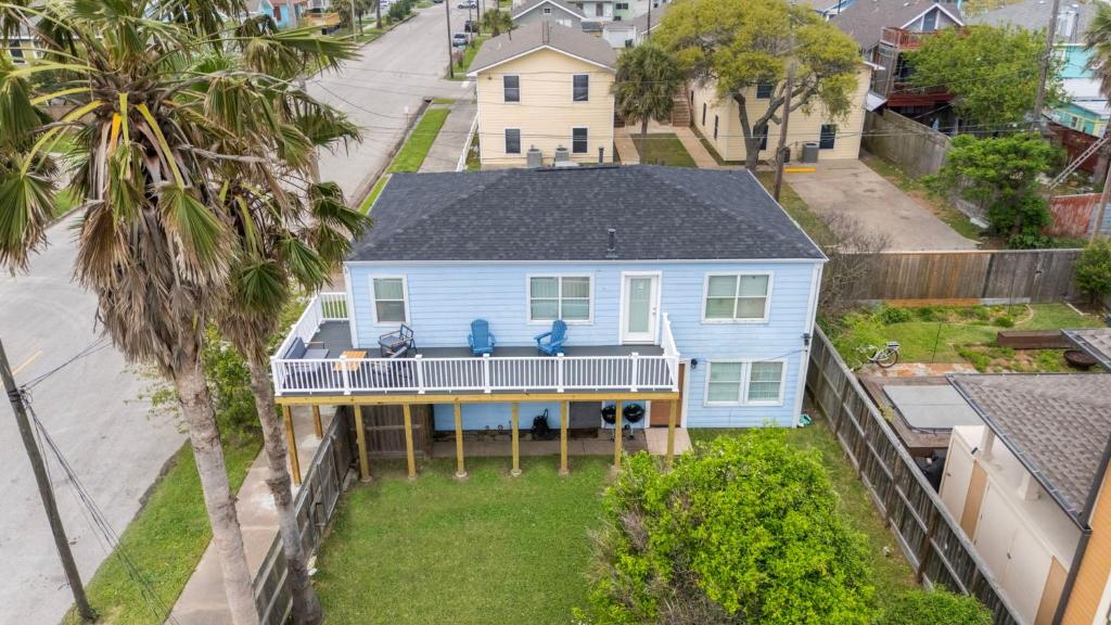 an aerial view of a blue house with a porch at Beach lovers dream come true walking distance to the sandy shores in Galveston