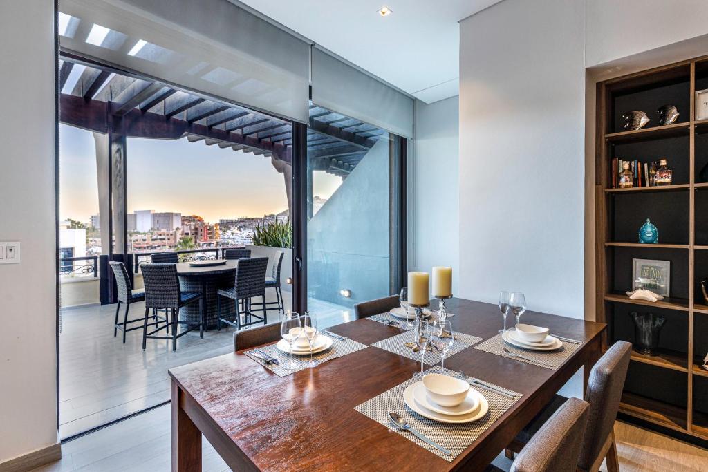 a dining room with a table and some chairs at Hot Spot Overlooking Cabo Marina Private Terrace in Cabo San Lucas