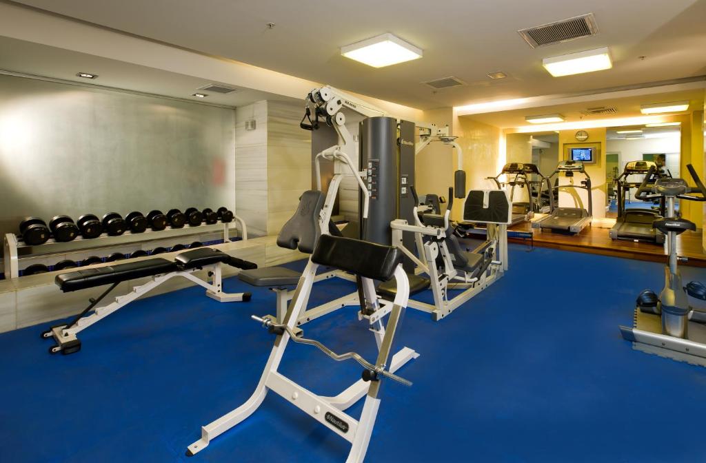 a gym with treadmills and machines in a room at Divan Istanbul City in Istanbul