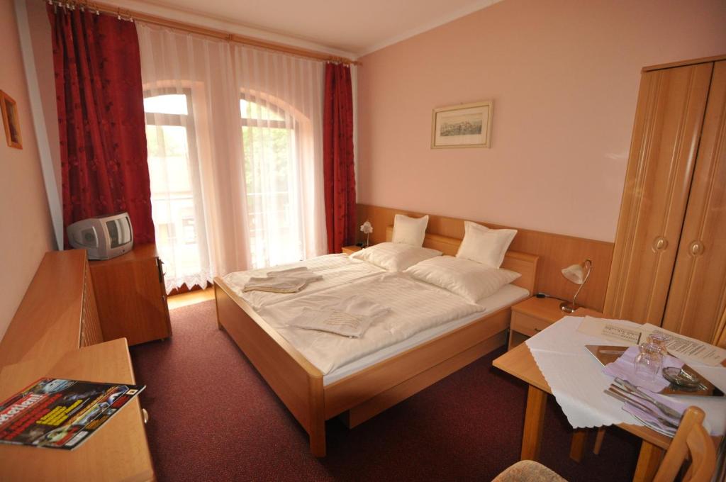 Postel nebo postele na pokoji v ubytování Hotel Átrium