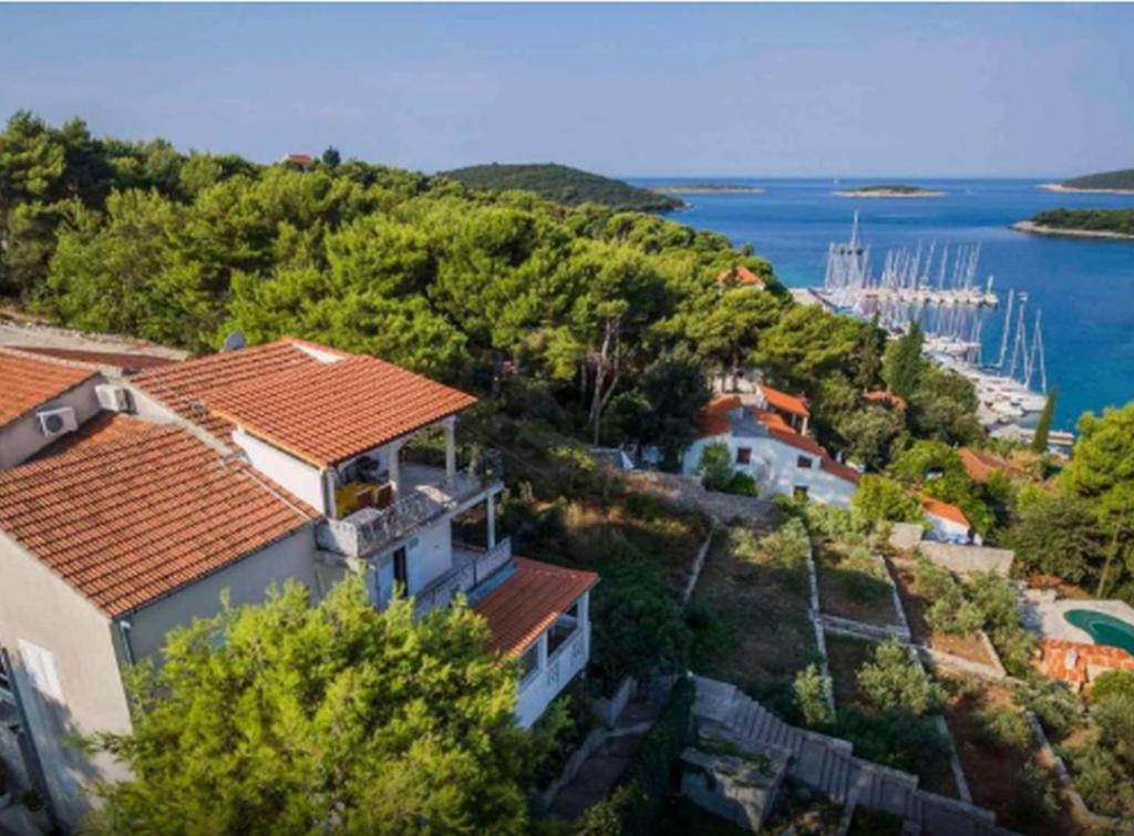 an aerial view of a house on a hill next to the water at Apartments Vesna in Maslinica