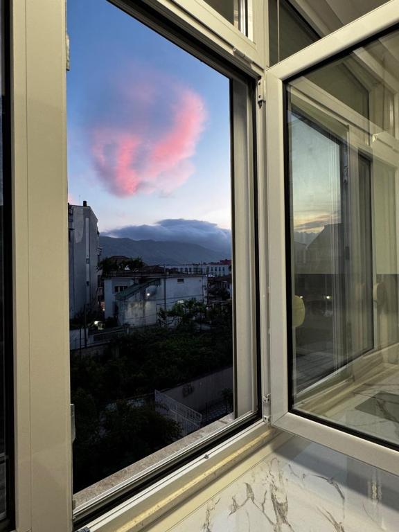 a window with a view of the sky at Mira's Apartment in Shkodër