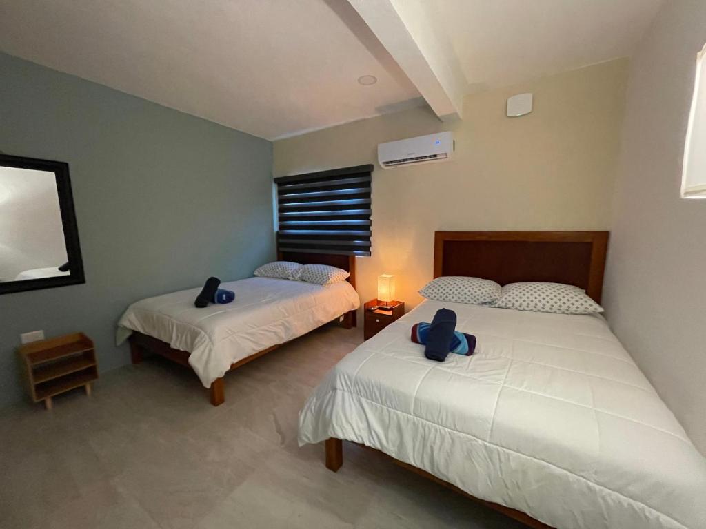 Postel nebo postele na pokoji v ubytování Casona Suites