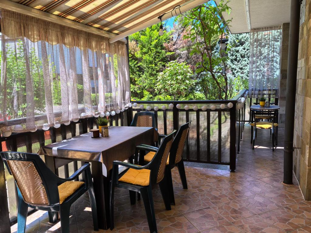 a patio with tables and chairs on a balcony at Stela Apartment in Santa Marina Holiday in Sozopol