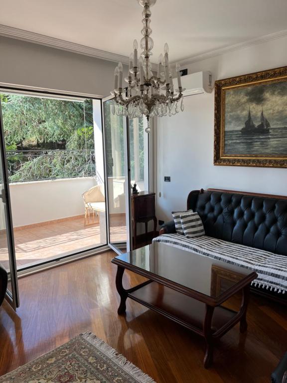 a living room with a couch and a table at Montenegro Seaside Lux Apartment in Petrovac na Moru
