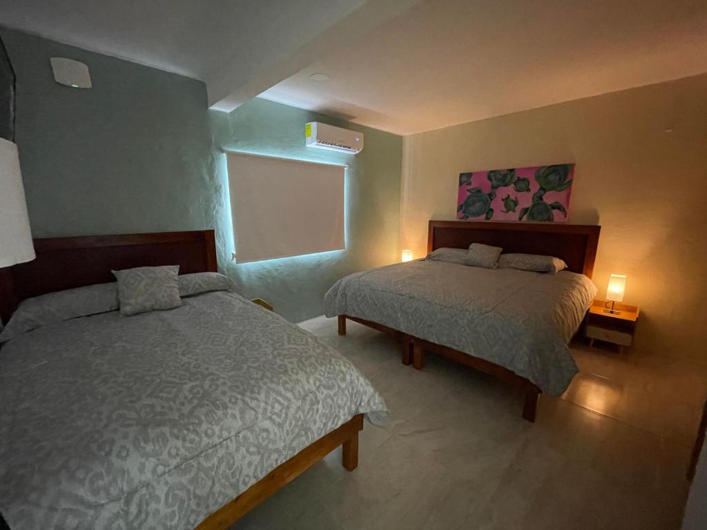 Postel nebo postele na pokoji v ubytování Casona Suites