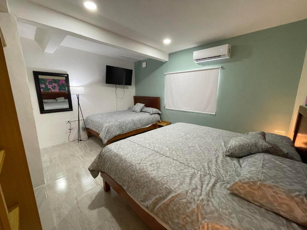 Postel nebo postele na pokoji v ubytování Casona Suites