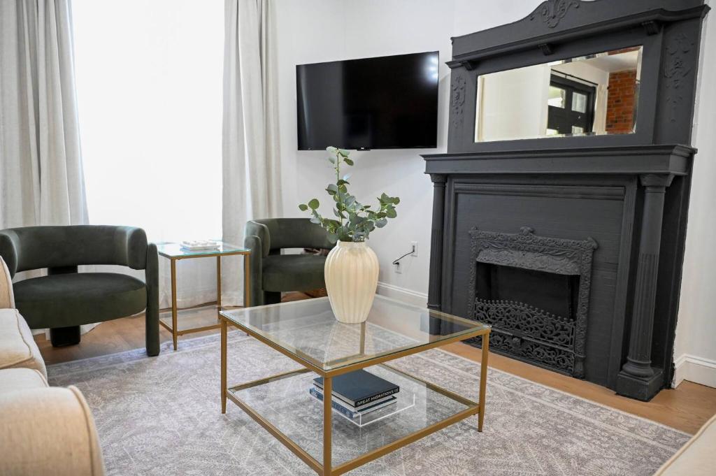 a living room with a fireplace and a glass table at St. Louis Luxury Home 3BR/3.5BA Near Everything in Soulard
