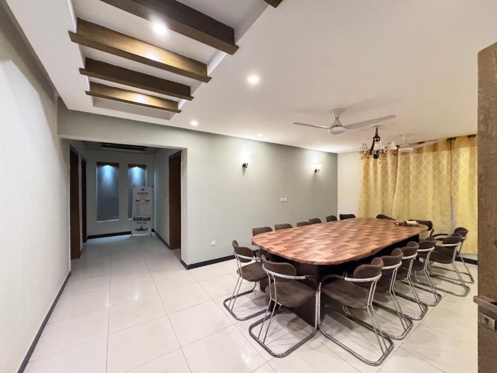a conference room with a wooden table and chairs at Alpine lodges in Islamabad