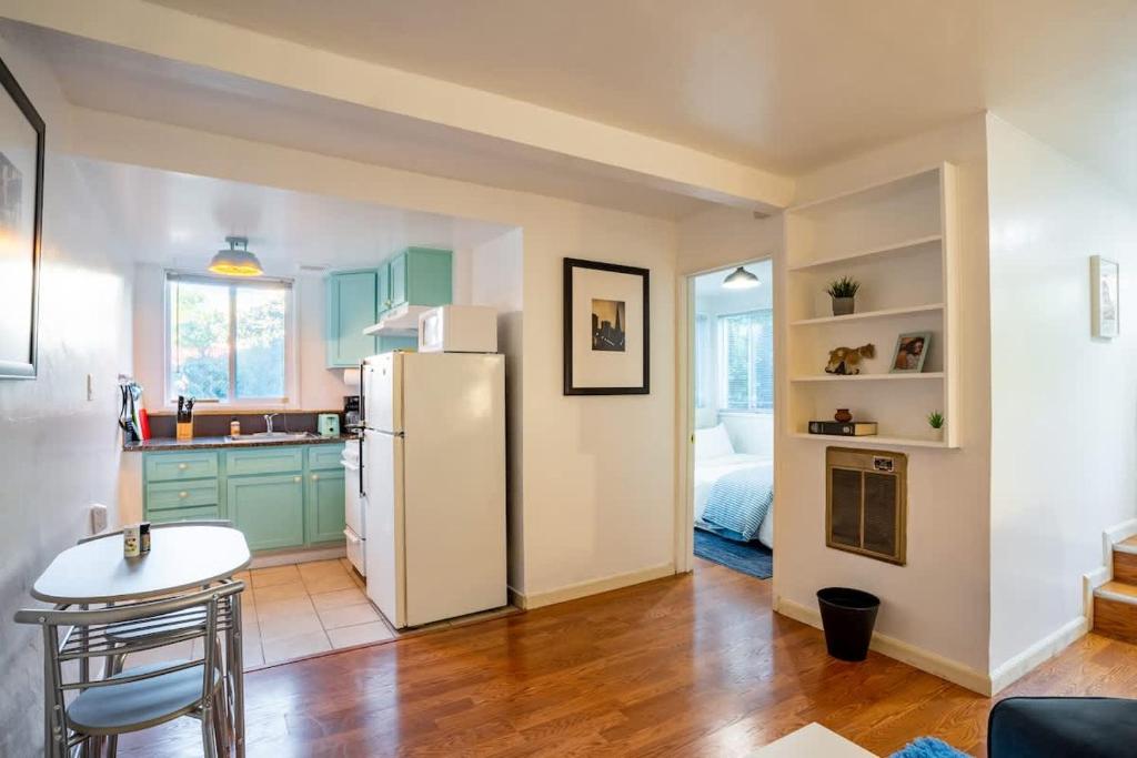 a kitchen with green cabinets and a white refrigerator at Garden Oasis Cozy Home Near Bart Shop with Parking in Berkeley