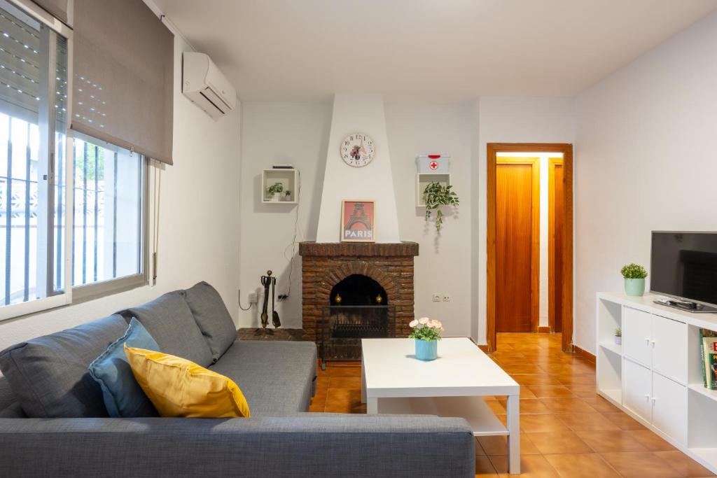 a living room with a couch and a fireplace at Villa Biznaga in Rincón de la Victoria