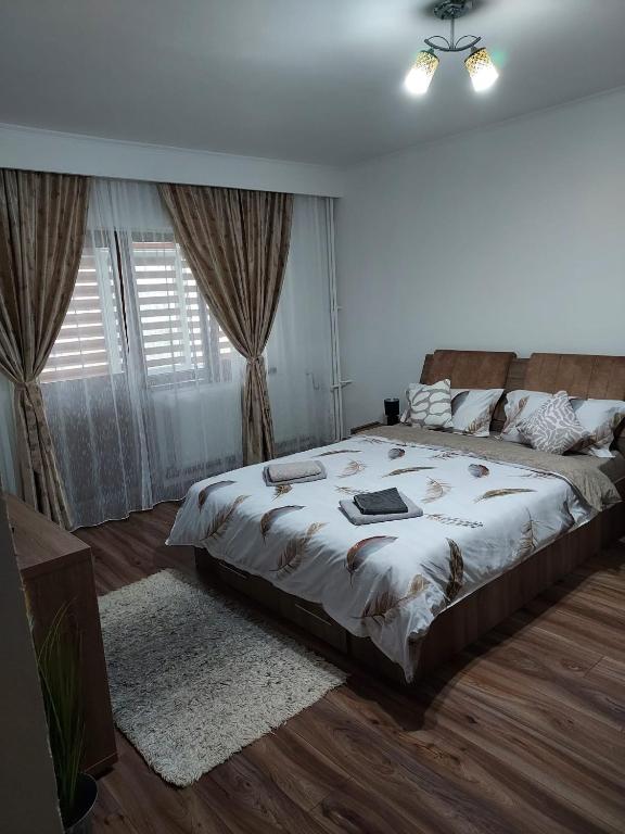 a bedroom with a bed with a laptop on it at Studio Ștefan in Călimăneşti