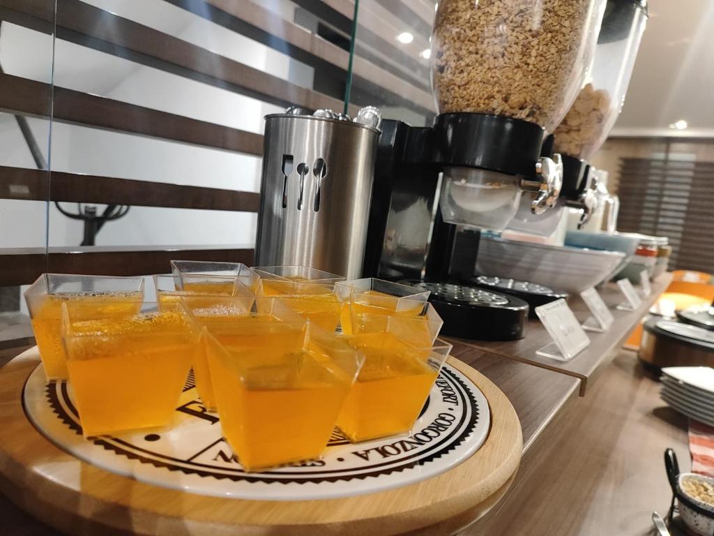 a tray of glasses of orange juice on a counter at Scala 68 in Bogotá