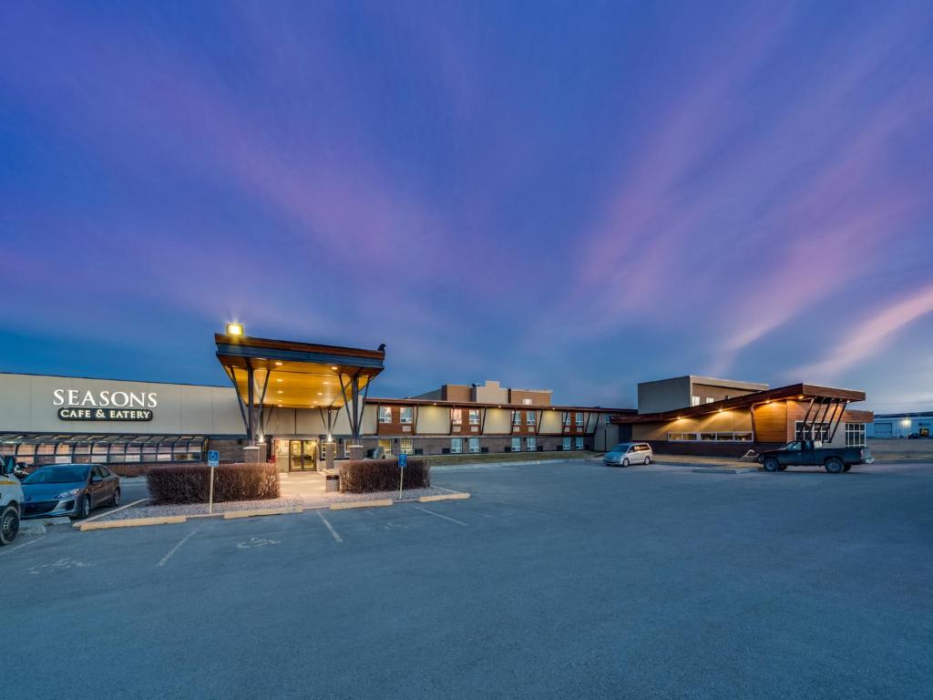 a parking lot in front of a shopping center at Heritage Inn Hotel & Convention Centre - Pincher Creek in Pincher Creek