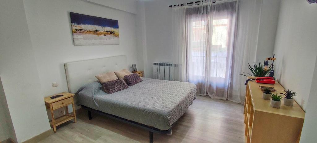 a small bedroom with a bed and a window at Casa Fausto Lasarte-oria in Lasarte