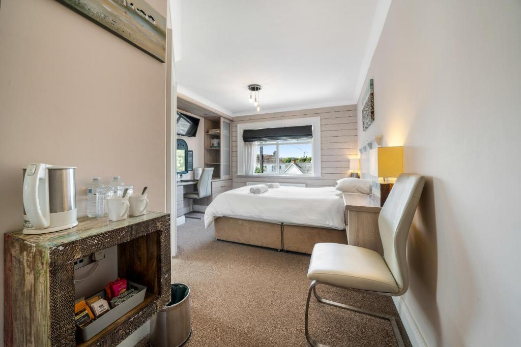 a bedroom with a bed and a tv in a room at Anvershiel House in Portrush
