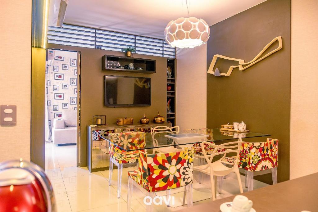 a dining room with a glass table and chairs at Apt. Beira Mar em Cotovelo In Mare 137 - QAVI in Granja Beira Mar