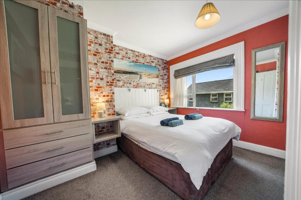 a bedroom with a large bed and a window at Anvershiel House in Portrush